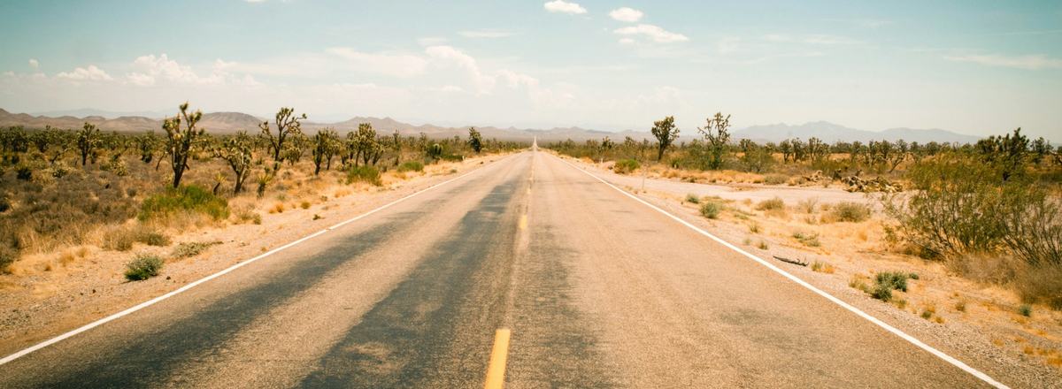 Open highway through the Arizona desert under a blue sky
